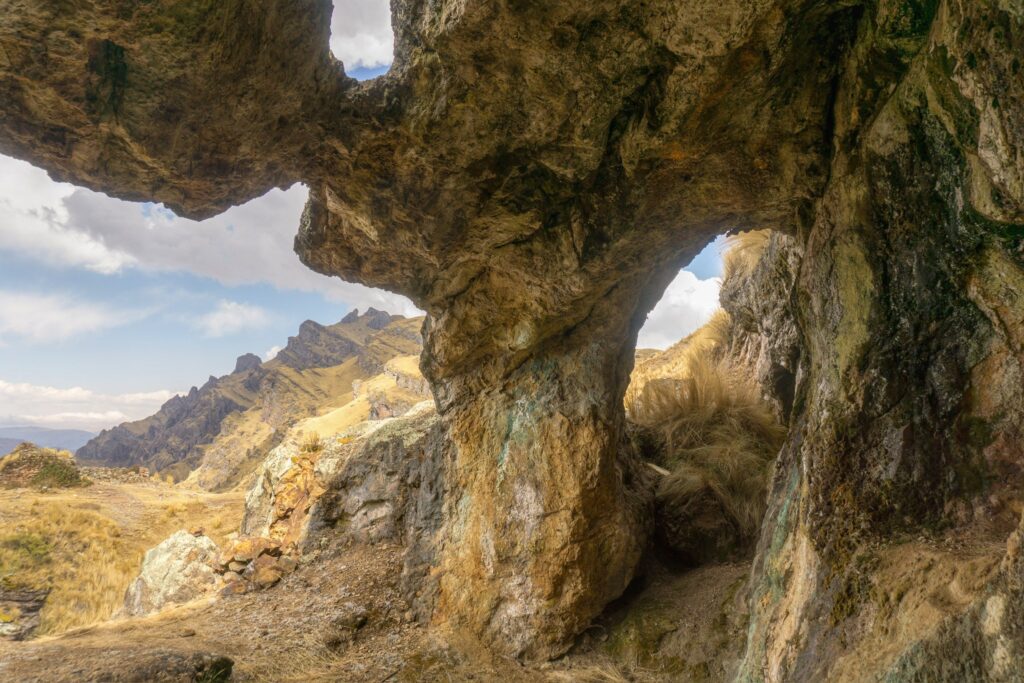 A natural rock arch standing open against the sky.