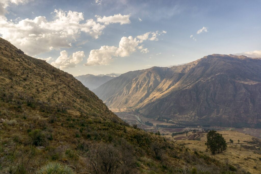A wide valley seen from high ground, ridges falling away into haze.